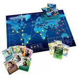 The components of the board game Pandemic laid out on a table. The main game board displays a world map with interconnected cities, and there are several card decks and player pawns arranged around it